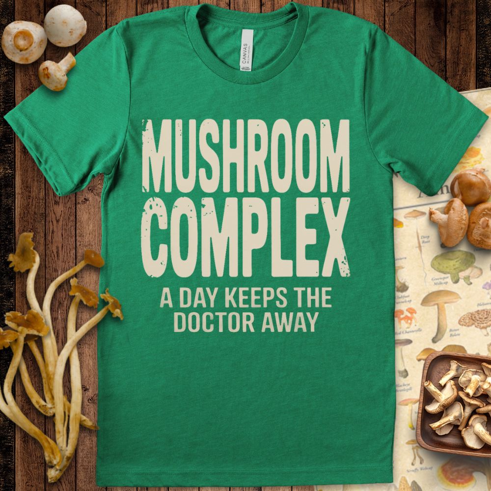 Graphic tee with bold text “Mushroom Complex – A Day Keeps the Doctor Away” for mushroom and wellness enthusiasts