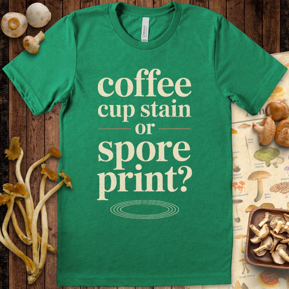 Funny mushroom-themed T-shirt with the phrase “coffee cup stain or spore print?” in vintage typography