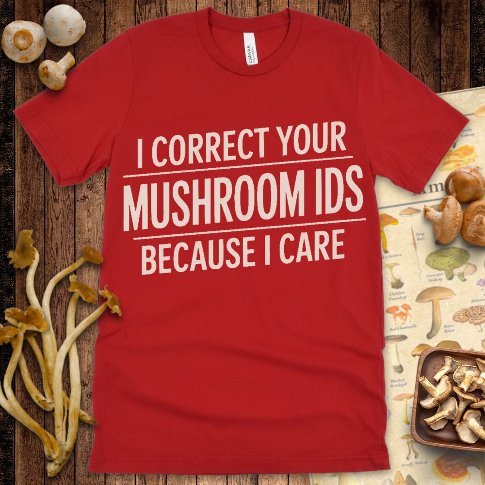 Modern graphic t-shirt with bold cream text reading “I Correct Your Mushroom IDs Because I Care” with underlined emphasis on a black background