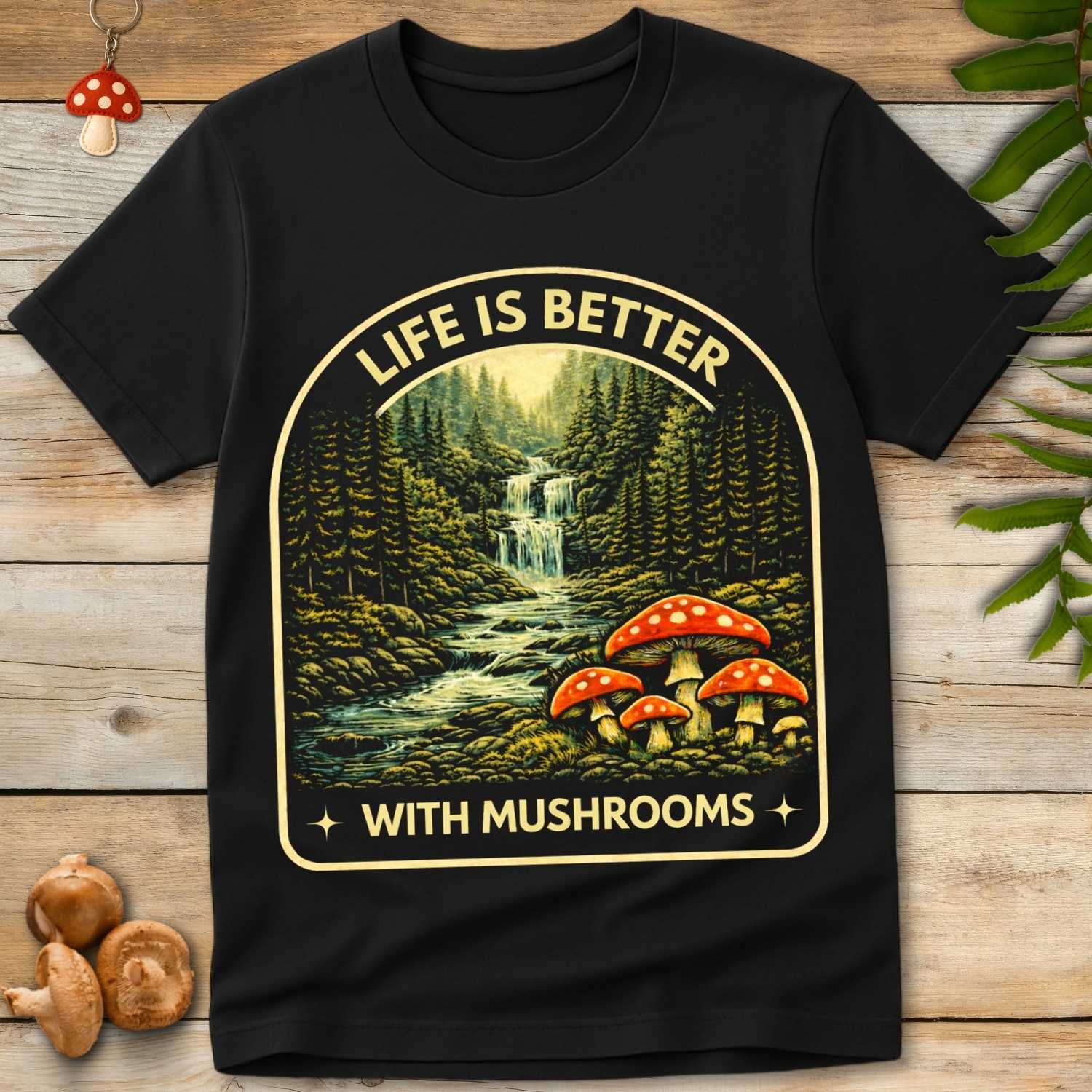 Vintage style forest waterfall landscape with red spotted mushrooms and text “Life Is Better With Mushrooms”.