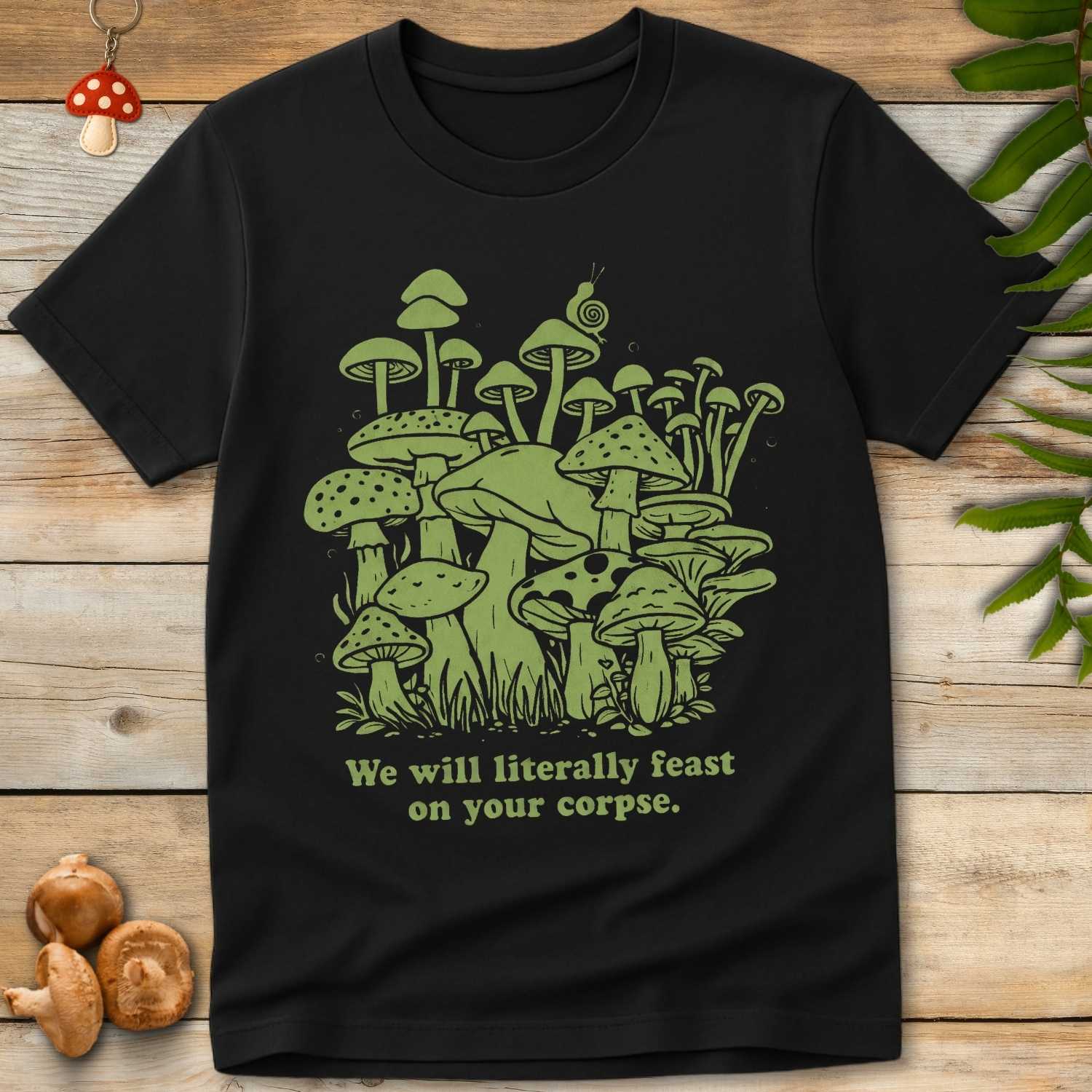 Illustration of green mushrooms with a snail and the caption “We will literally feast on your corpse” in a humorous, dark eco-themed design.