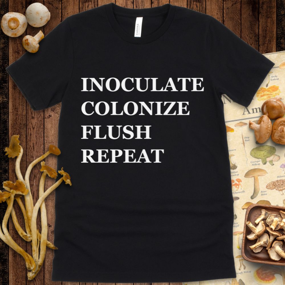 Black t-shirt design with bold white text reading "Inoculate, Colonize, Flush, Repeat" in all caps.