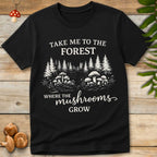 T-shirt design with mushrooms in a forest clearing and text that reads “Take Me to the Forest Where the Mushrooms Grow” in vintage-style font