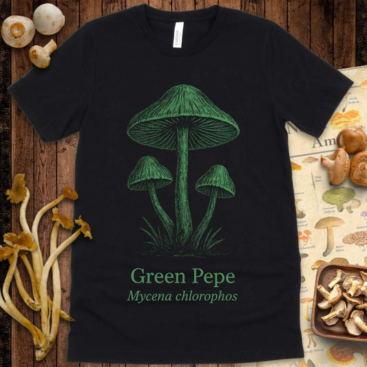 Illustration of three green Mycena chlorophos mushrooms with vintage typography reading "Green Pepe" on black t-shirt
