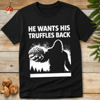 white illustration of Bigfoot holding a truffle with bold text reading “He Wants His Truffles Back” above a forest silhouette
