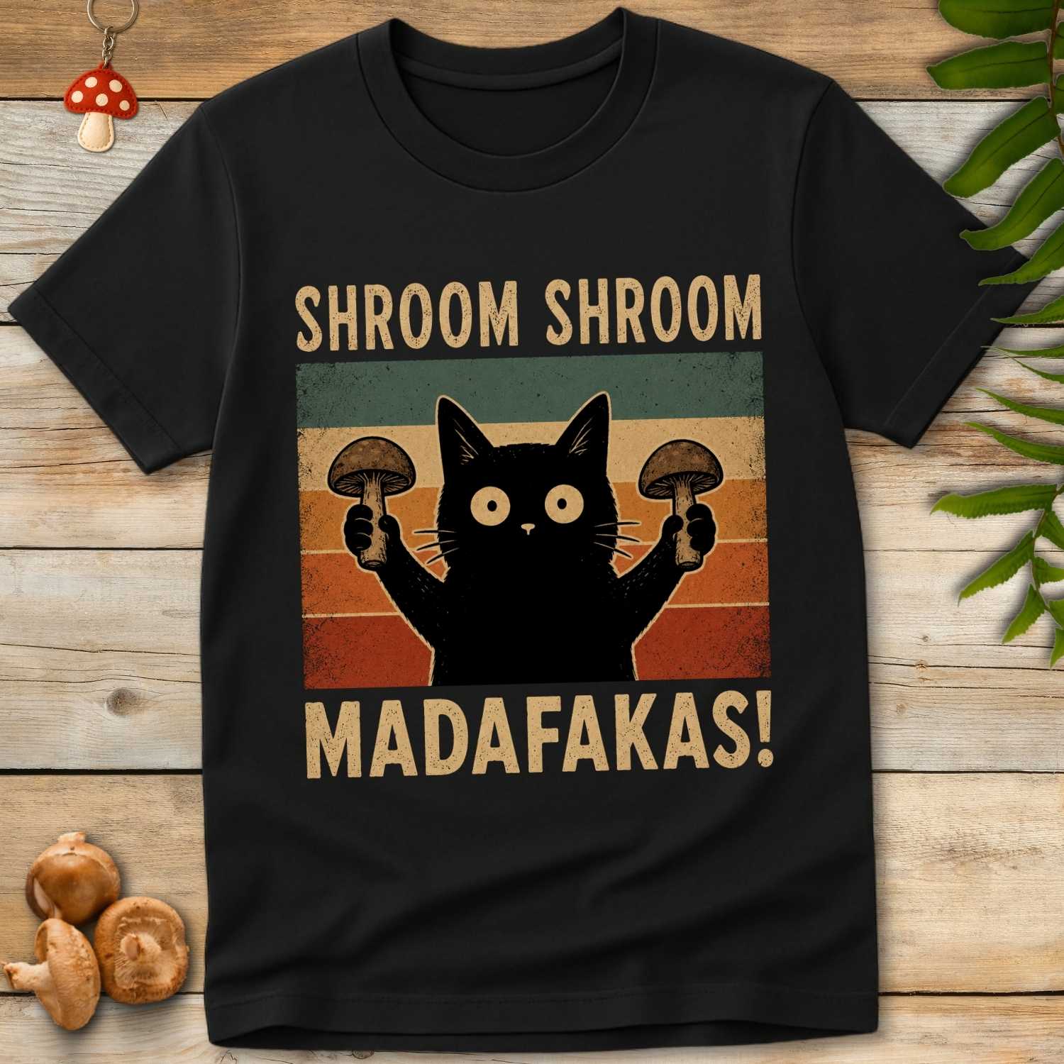Shroom Shroom Tee featuring a black cat holding mushrooms with retro vintage sunset stripes and funny mushroom humor text.