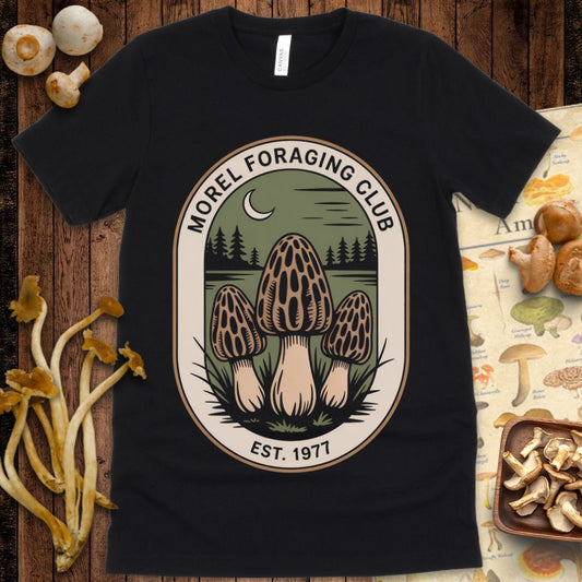 Vintage-style patch design with three morel mushrooms, crescent moon, and pine trees under the words “Morel Foraging Club – Est. 1977”