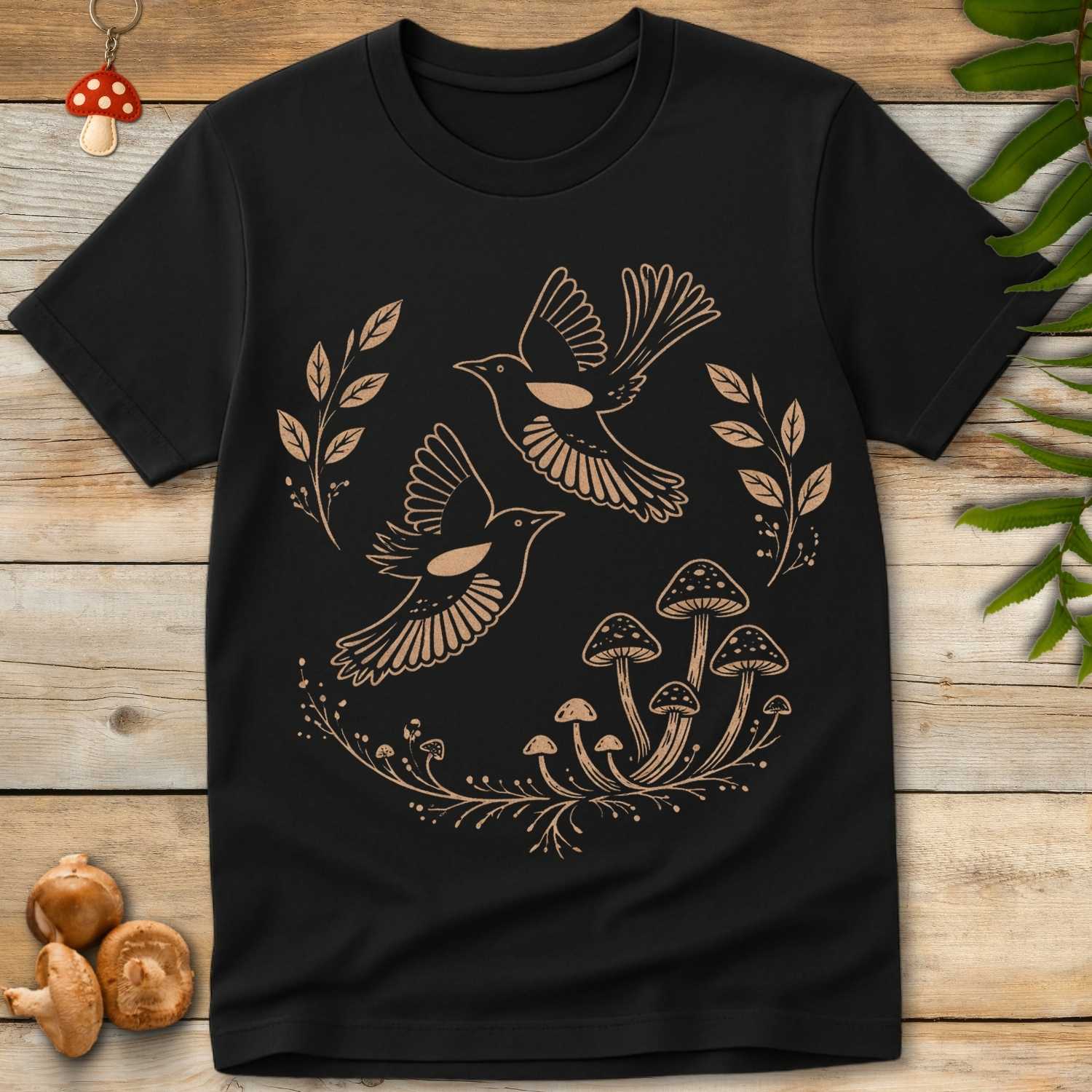 Folk-style illustration of two birds in flight surrounded by leaves and mushrooms in a woodland nature design.
