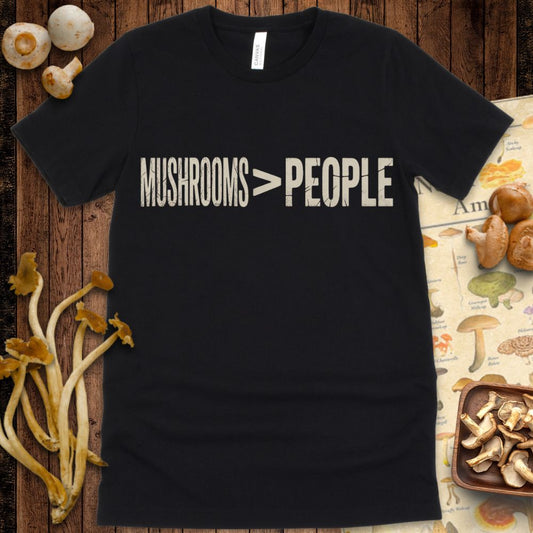 Vintage-style t-shirt design featuring distressed text that reads "Mushrooms > People" in bold, minimalist cream font on black background
