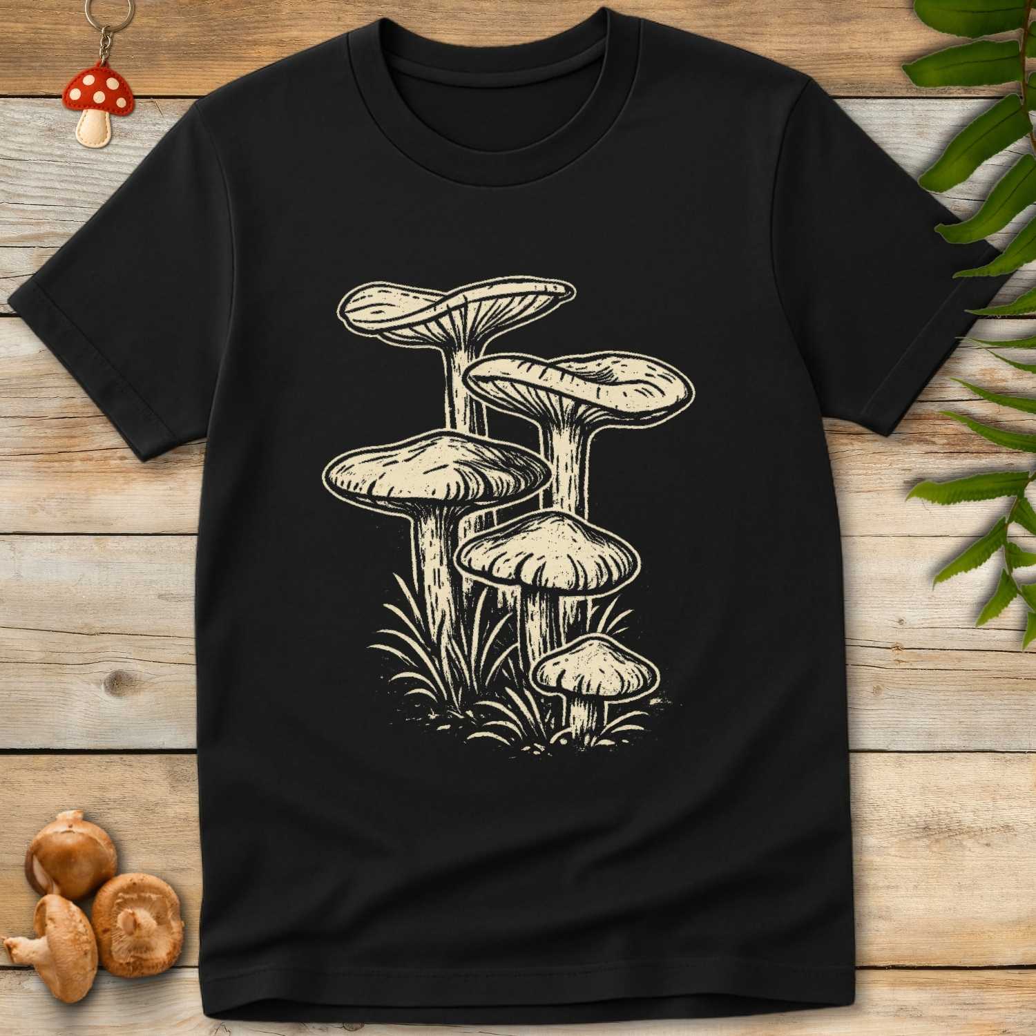 Vintage hand-drawn mushroom cluster sprouting from forest grass on a nature-inspired T-shirt design