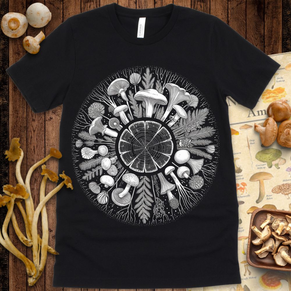 Detailed black and white mandala of mushrooms, leaves, roots, and a central tree ring forming a circular nature-inspired design