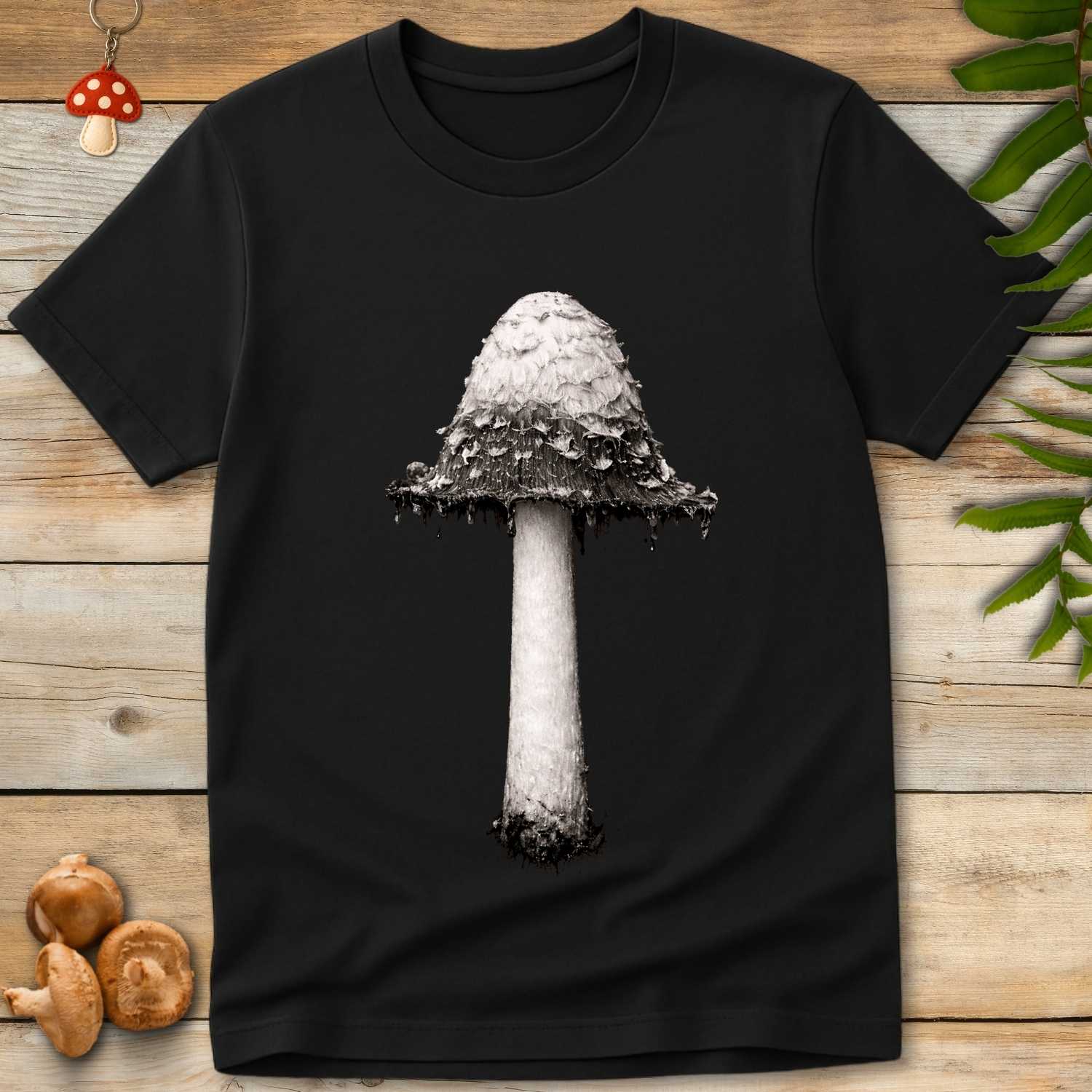 Grunge-style image of a Shaggy Ink Cap mushroom with a tall stem and layered cap in black-and-white on a dark background