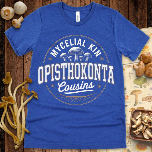 Badge-style T-shirt design with mushrooms and the phrase "Mycelial Kin – Opisthokonta Cousins" in bold white and brown retro fonts