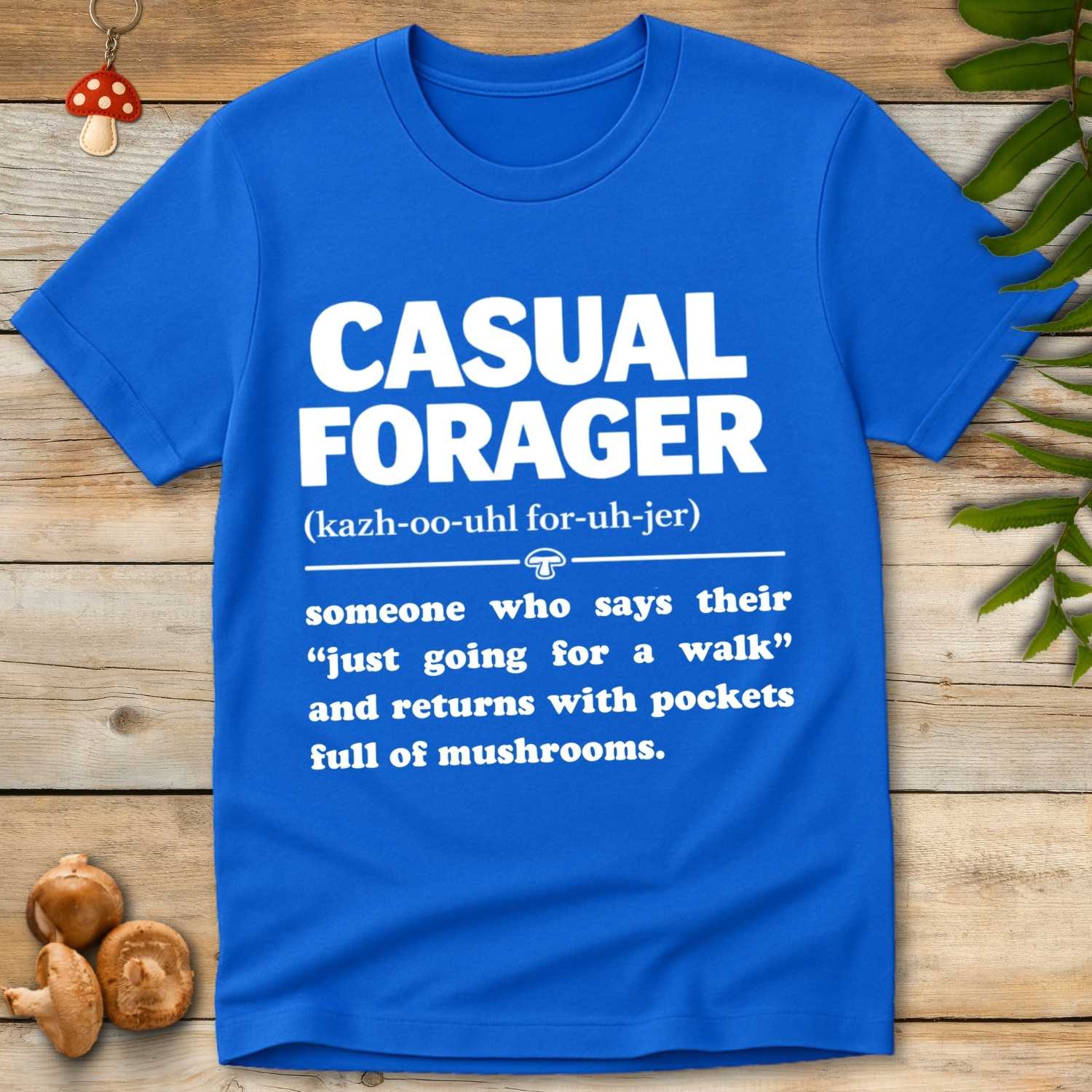 Typography design reading “Casual Forager” with a humorous definition about going for a walk and returning with pockets full of mushrooms.