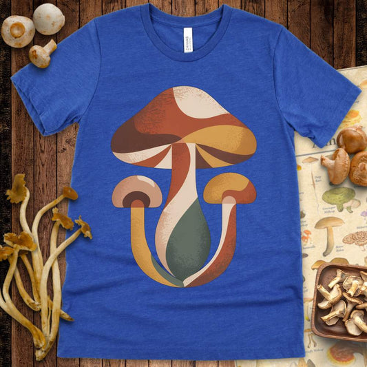 Stylized retro mushroom trio in warm earthy tones and curved shapes on a graphic tee
