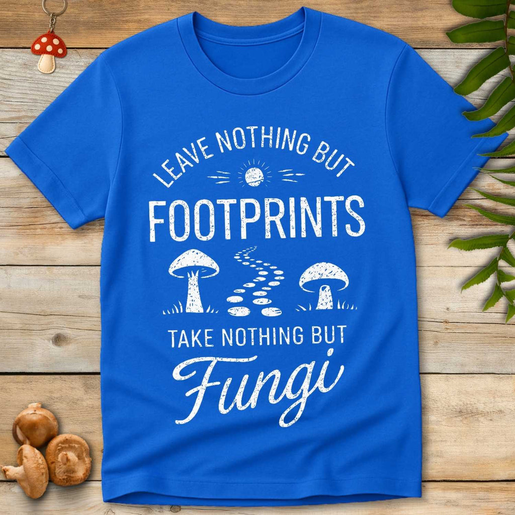 Vintage style design reading “Leave Nothing But Footprints” with mushrooms, a winding trail of footprints, and a rising sun on a blue shirt.