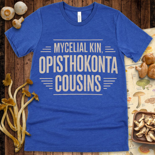 Minimalist T-shirt design with bold tan text reading “Mycelial Kin, Opisthokonta Cousins” surrounded by simple decorative lines