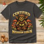 Smiling green goblin sitting among red and white toadstool mushrooms with the words "Certified Mushroom Goblin" in a fantasy-inspired vintage design.