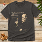 Vintage-style illustration of Sigmund Freud holding a mushroom with the text “The Interpretation of Dreams” on a grey background graphic t-shirt design.