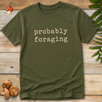 Probably Foraging Tee featuring minimalist cream typography on a black background with cozy mushroom hunting aesthetic.