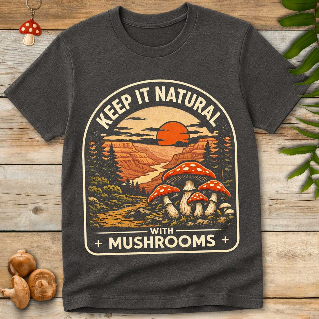 Vintage style design with red mushrooms, forest trees, canyon landscape, and sunset with text “Keep It Natural With Mushrooms”