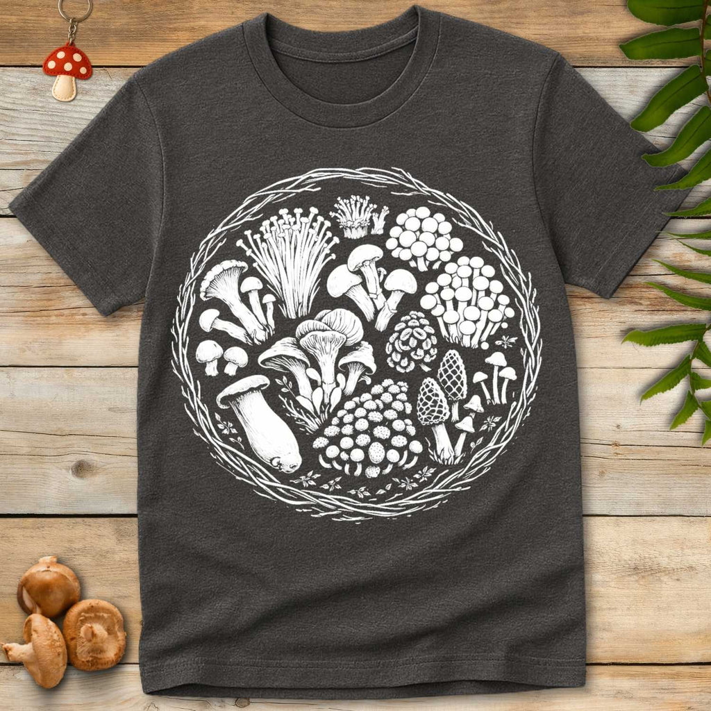 Detailed black and white circular wreath design featuring assorted wild mushrooms including chanterelles, morels, oyster mushrooms, and enoki.