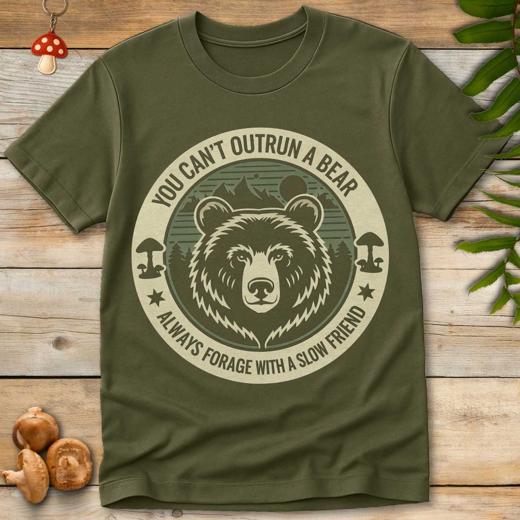 Circular design with a grizzly bear, mushrooms, and forest background, featuring the text “You Can’t Outrun a Bear – Always Forage with a Slow Friend.”