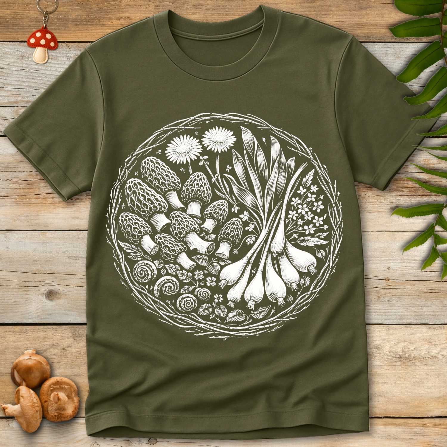 Detailed black and white circular design featuring morel mushrooms, garlic bulbs, herbs, and wildflowers.
