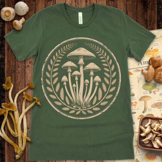 Vintage-style hand-drawn mushroom cluster surrounded by a laurel wreath on a graphic tee