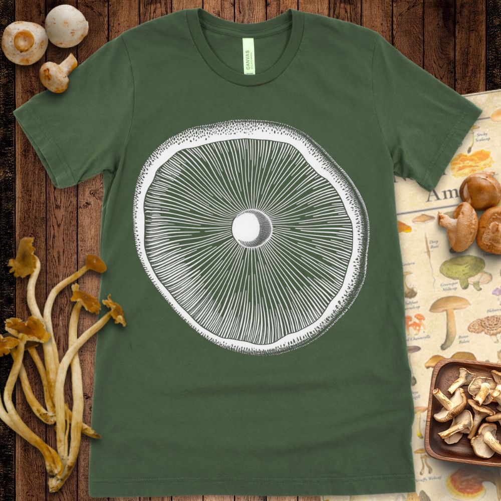 Intricate black-and-white illustration of a mushroom gill viewed from below in a radial pattern, printed on a T-shirt.
