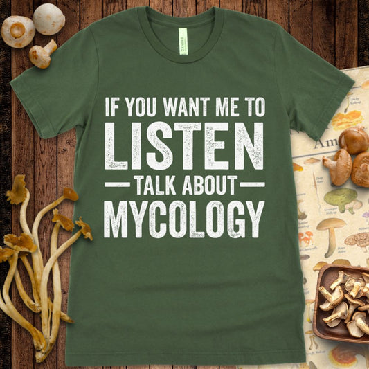 Black T-shirt with bold distressed white text that says "If you want me to listen, talk about mycology"