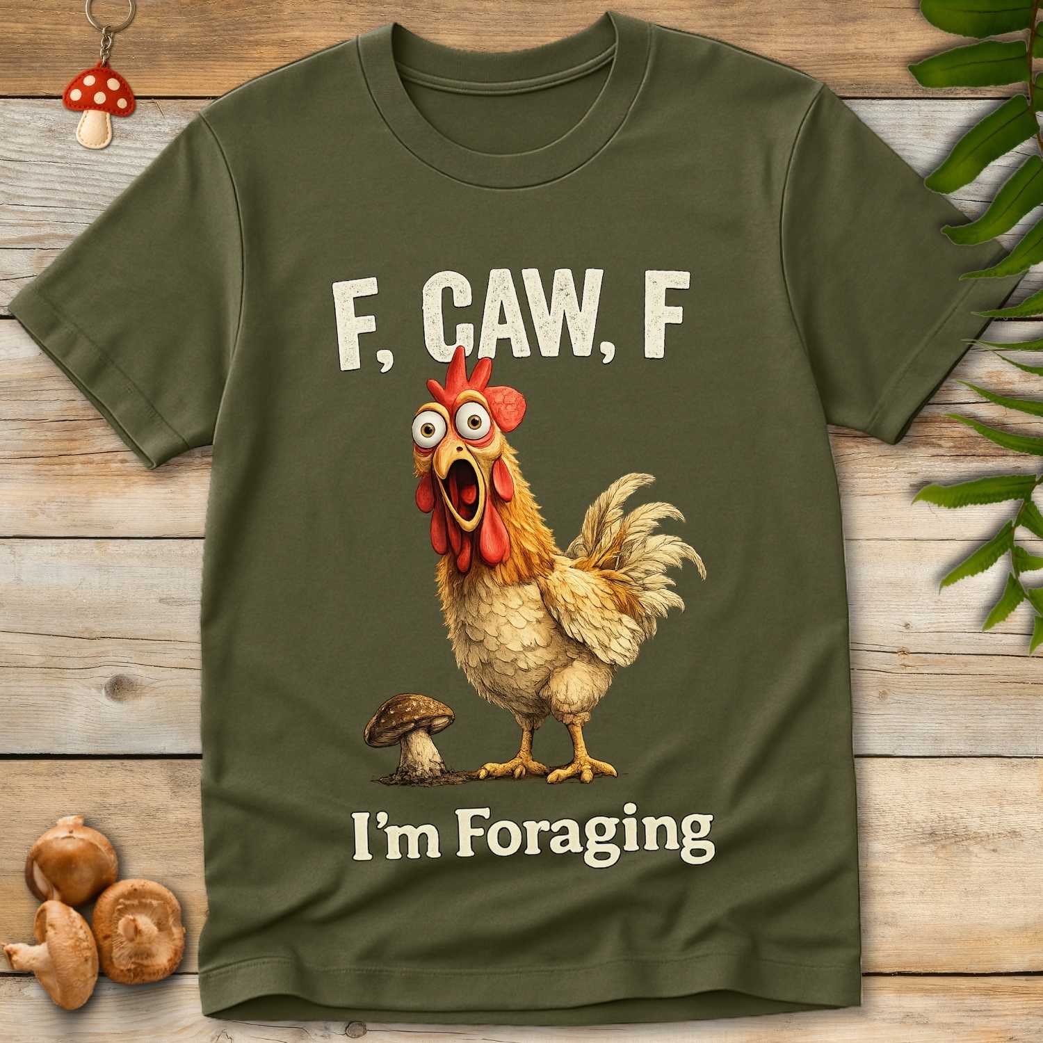 Goofy chicken shouting “F, Caw, F – I’m Foraging” next to a mushroom in a humorous foraging T-shirt design