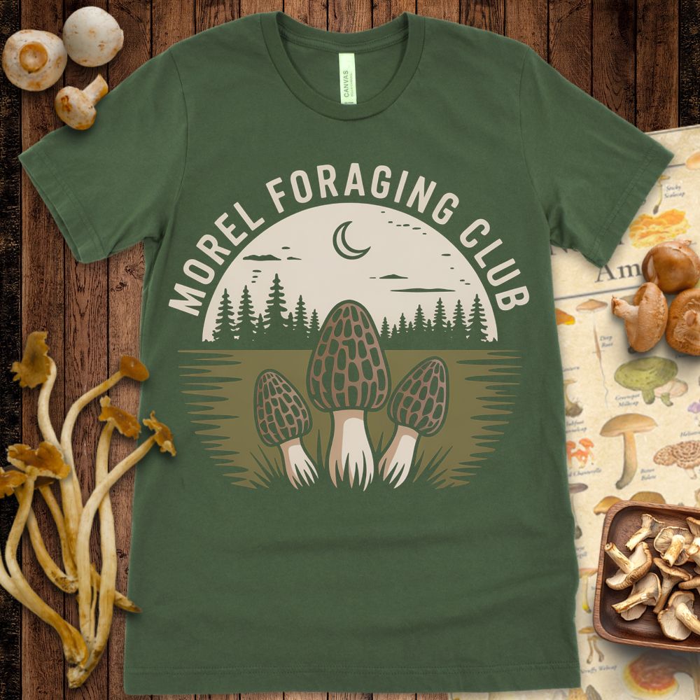 Design featuring three morel mushrooms in front of a pine forest and crescent moon, with the text “Morel Foraging Club” in a vintage outdoor style.