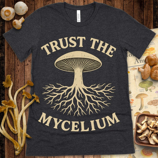 Vintage-style illustration of a mushroom with spreading mycelium roots and the text "Trust the Mycelium" on a graphic t-shirt design.