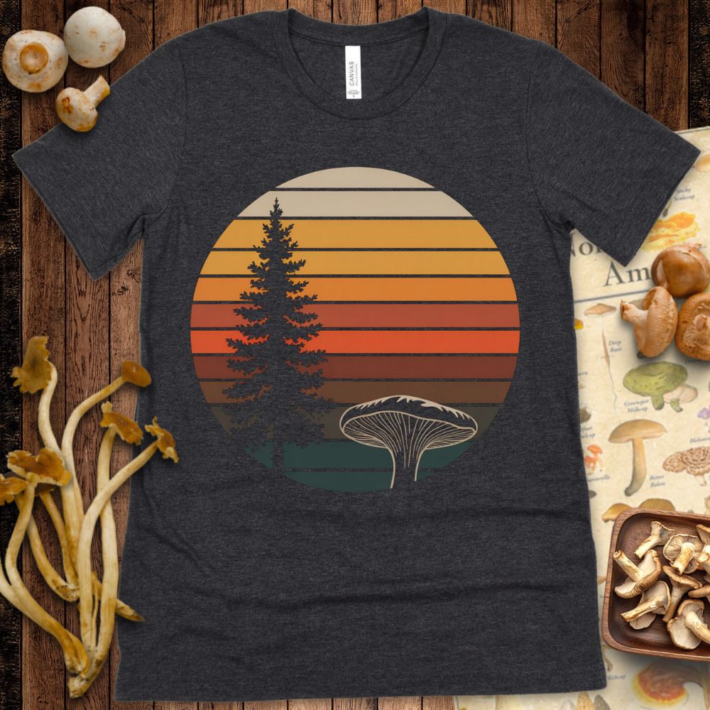 Retro-style circular design with a pine tree and large gilled mushroom in front of a warm sunset-striped background on black