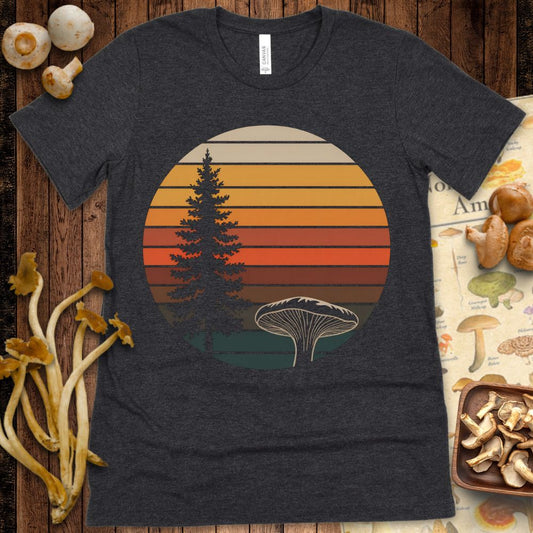 Retro-style circular design with a pine tree and large gilled mushroom in front of a warm sunset-striped background on black
