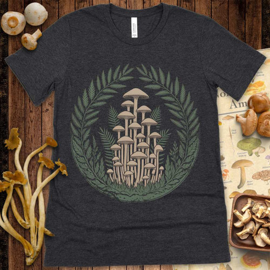 Detailed illustration of tall woodland mushrooms encircled by fern leaves on a graphic tee