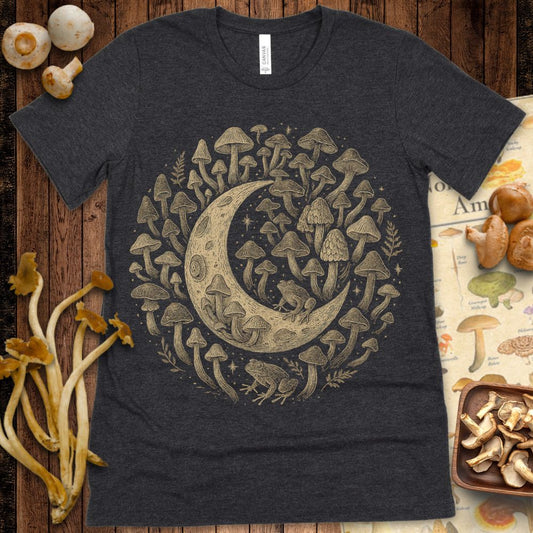 Intricate illustration of a crescent moon surrounded by mushrooms, stars, and frogs in a vintage gold-ink style on black background.