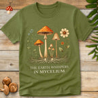 Illustration of colorful mushrooms and wildflowers with visible underground mycelium roots and the text “The Earth Whispers in Mycelium”.