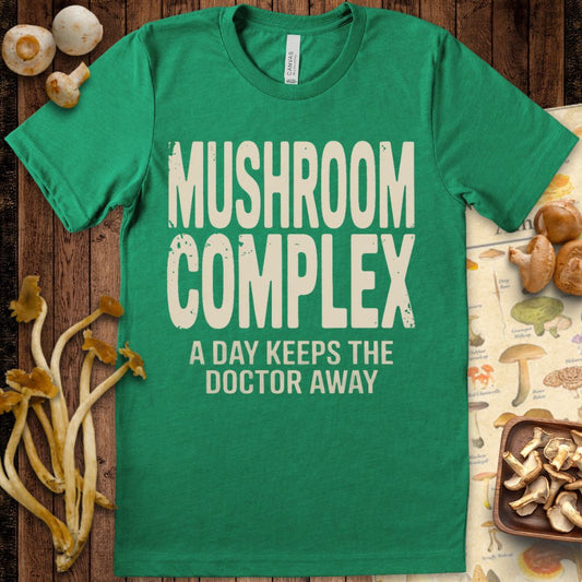 Graphic tee with bold text “Mushroom Complex – A Day Keeps the Doctor Away” for mushroom and wellness enthusiasts