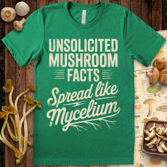 Vintage-style graphic t-shirt with bold cream text reading “Unsolicited Mushroom Facts Spread Like Mycelium” with root-style design at bottom