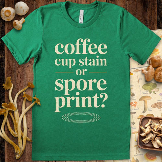 Funny mushroom-themed T-shirt with the phrase “coffee cup stain or spore print?” in vintage typography