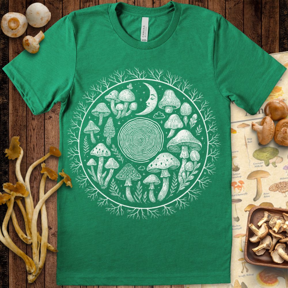 Black-and-white circular illustration of mushrooms, a crescent moon face, tree rings, and branching mycelium forming a cosmic mandala.