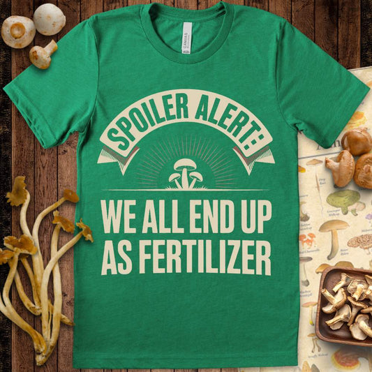 T-shirt design with the phrase “Spoiler Alert: We All End Up As Fertilizer” and illustrated mushrooms in a vintage sunburst style