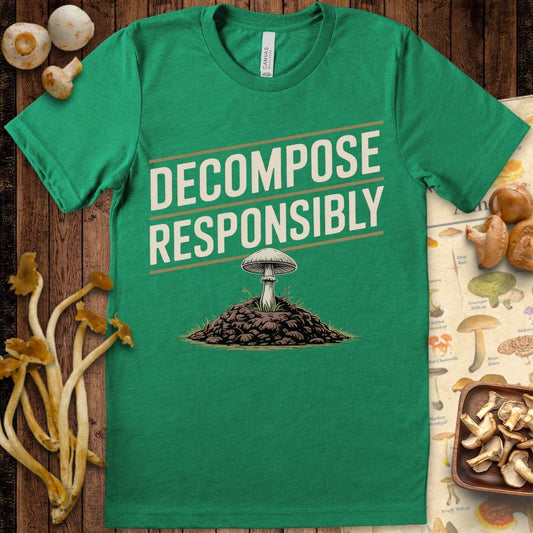 T-shirt with diagonal text reading “Decompose Responsibly” and a mushroom growing from a mound of soil and leaves