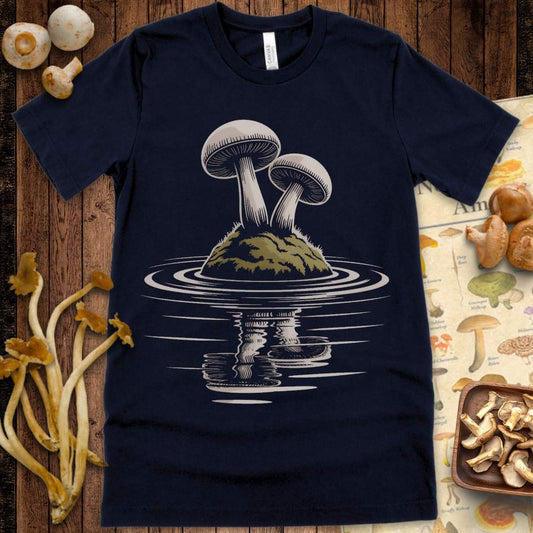 Two mushrooms on a mossy island reflected in rippling water on a graphic tee