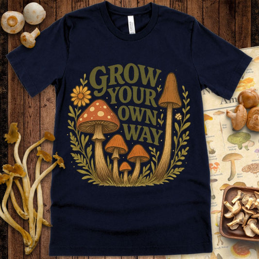 Illustration of mushrooms with flowers and leaves and the text “Grow Your Own Way” in a vintage cottagecore style