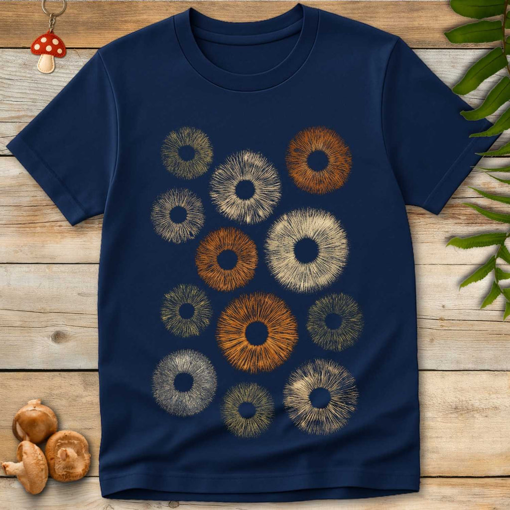 Navy T-shirt featuring a symmetrical arrangement of colorful spore print circles in natural shades of brown, green, and cream