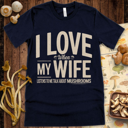 Text-based design reading “I Love When My Wife Listens to Me Talk About Mushrooms” with small illustrated mushrooms