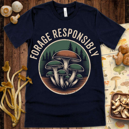 Vintage-style t-shirt graphic showing a cluster of mushrooms in front of pine trees with the phrase “Forage Responsibly” above